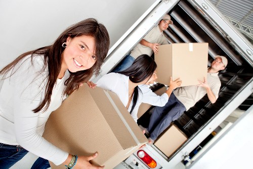 Professional removals crew working with safety checks and protection