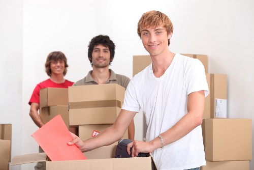 Professional movers loading furniture into a removal van in Shepherdsbush